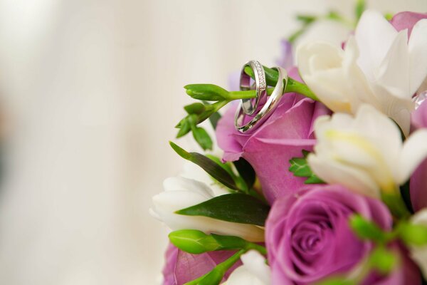 Bagues de fiançailles sur un bouquet de fleurs panachées