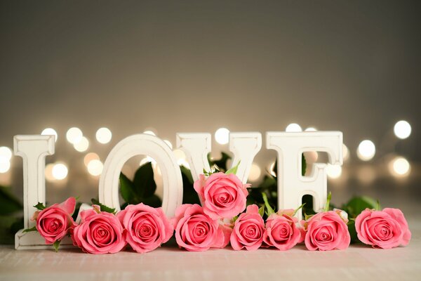 Pink roses with the inscription love