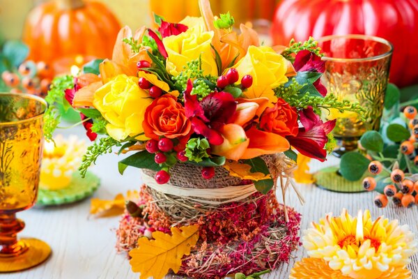 A bouquet of flowers and a candle on the table