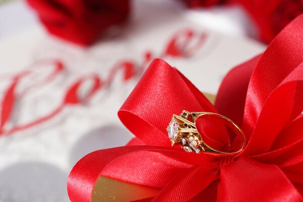 A massive ring with a stone on a red bow