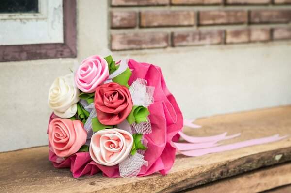 Bouquet of satin roses on a tree