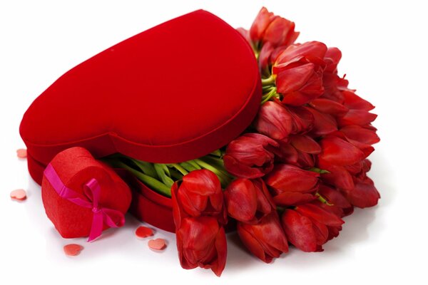 Red tulips in a box in the form of a heart