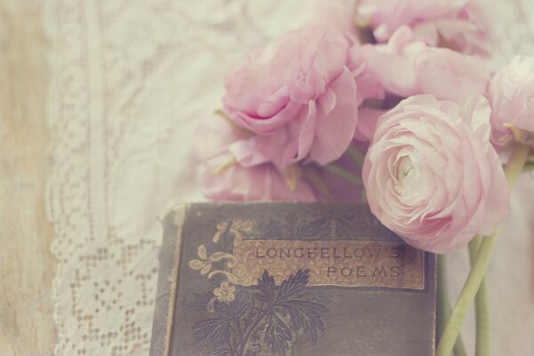 Rosebuds of buttercups with a book