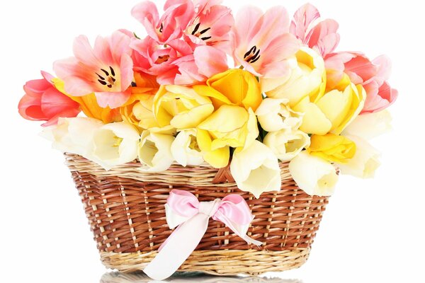 The basket with flowers is decorated with a pink bow