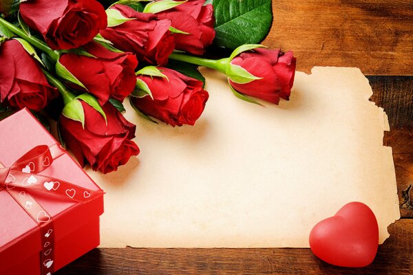 An empty place for congratulations with roses, a heart and a gift