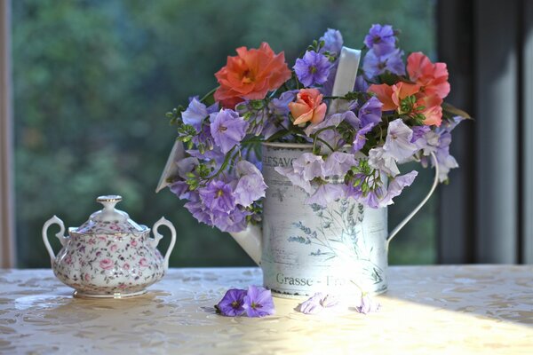Atmospheric photo of a sugar bowl and watering can