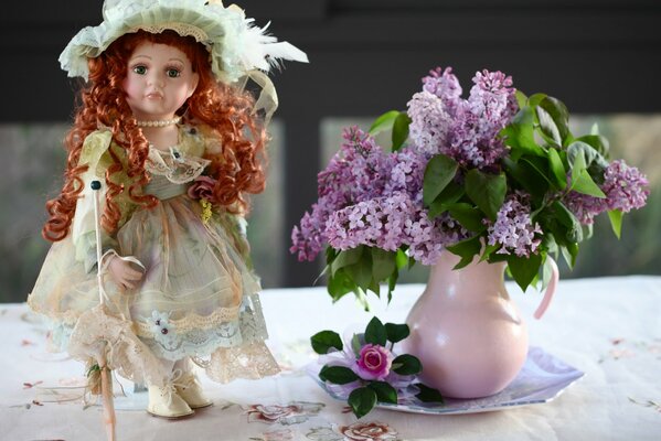 Beautiful, doll and bouquet of lilac