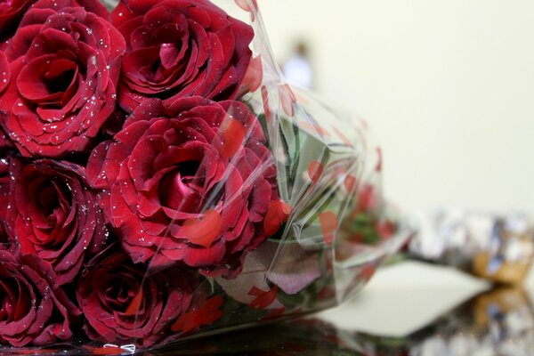 Bouquet of burgundy roses in a transparent package