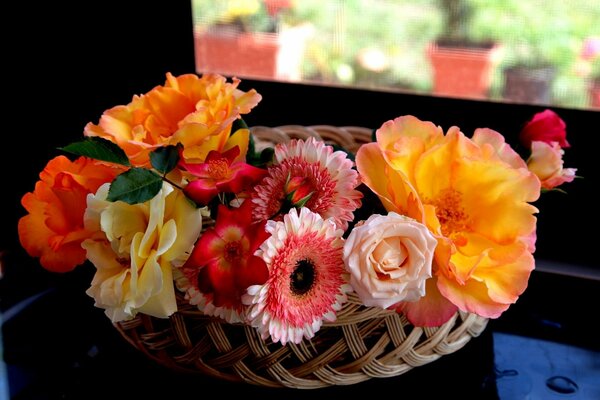 Bouquet of roses and gerberas in a basket