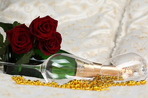 Scarlet roses on a bottle of champagne