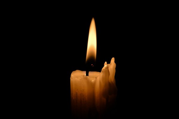 Mourning black background with candle