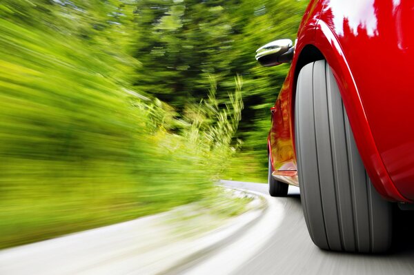 Red car at speed in a turn