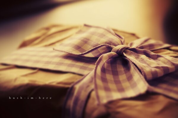 An intriguing gift with a lavender ribbon