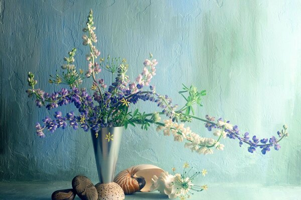 Vase with flowers and shells