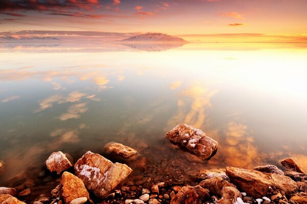 Dawn at sea. Rocks on the shore