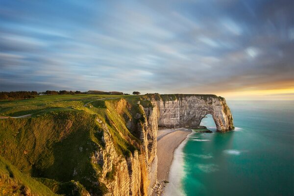 View of the beach with a cliff and an arch