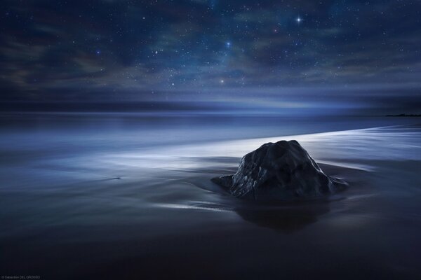 Olinokaya rock on the background of the ocean and stars