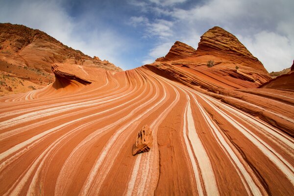 Orange canyon with textured lines on a blue sky background