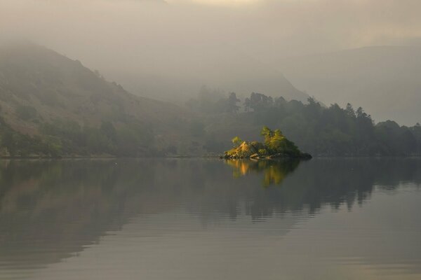 The surface of the lake with the reflection of hills and islands in it