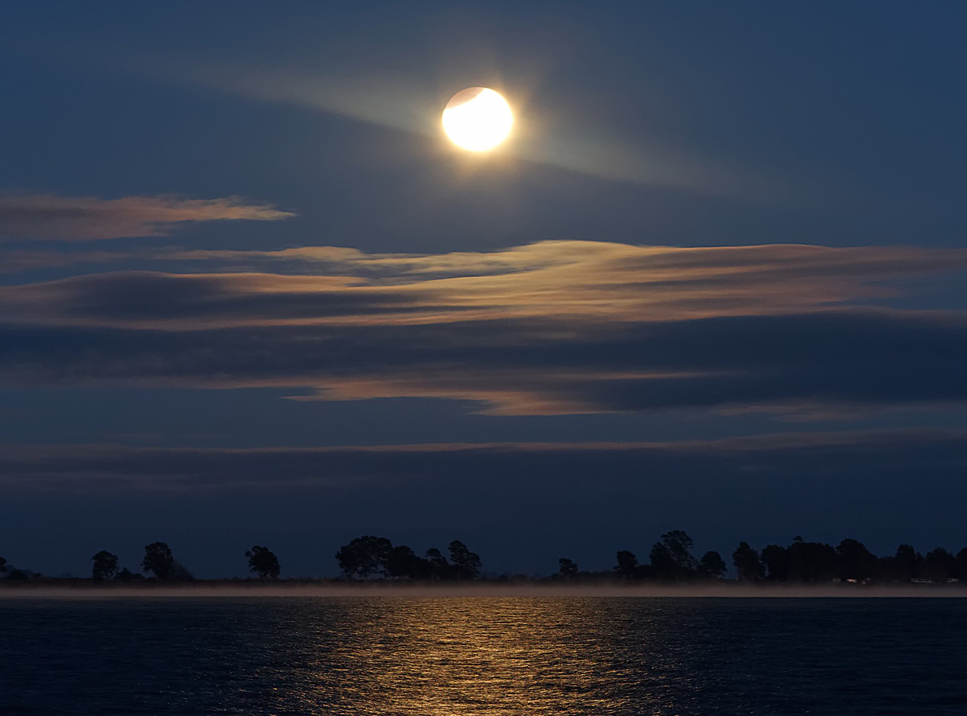 moon eclipse lagoon reflection fog