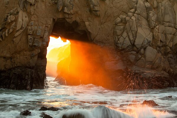 The light of the sun coming through the rocks
