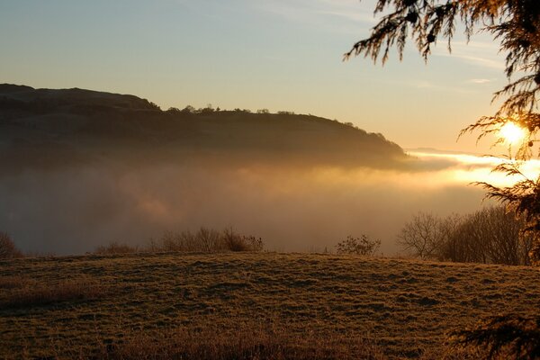 Sunset in the mountains through the clouds landscape