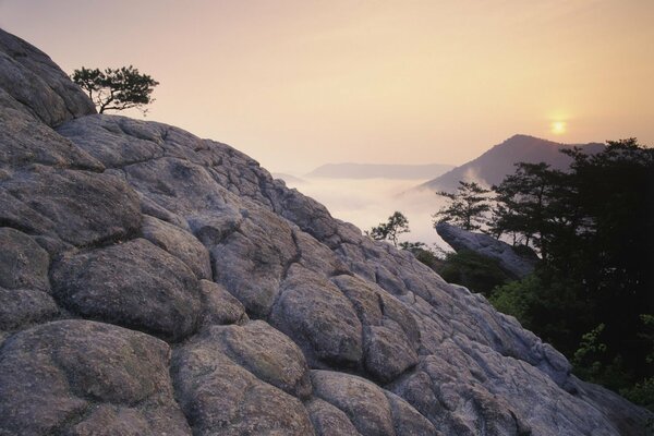 Sunset in the mountains high on a rock