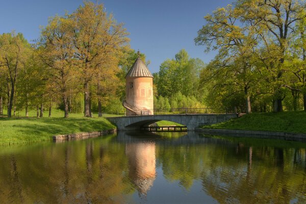 Reflection of a bridge with a tower in a pond