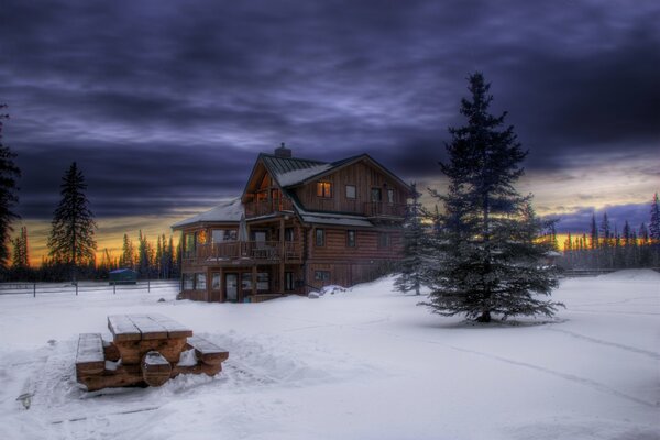 Wooden house in the snow in winter