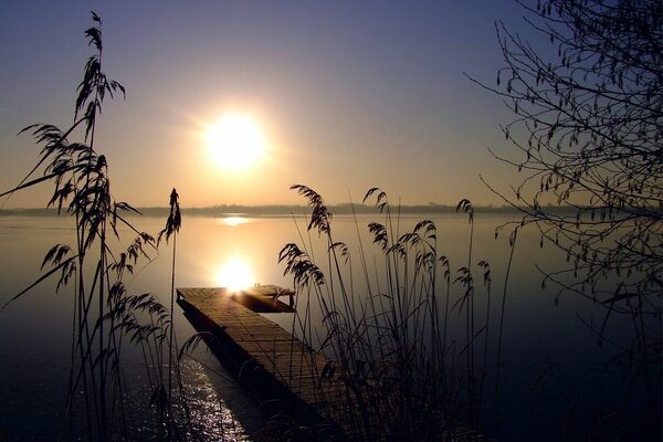 Puesta de sol en el cielo sin nubes en el lago