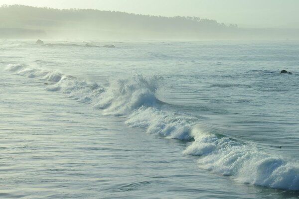 The sea foams with white waves