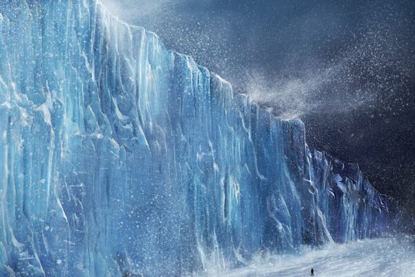 A man walks through an icy blizzard