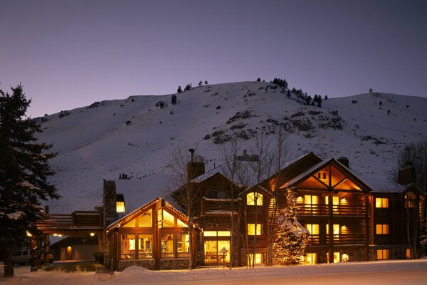 Grande maison sur fond de montagne en hiver