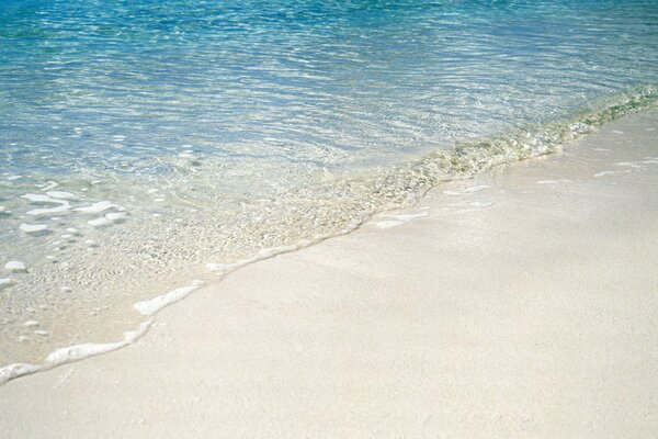 The beach has very warm sand and clear water
