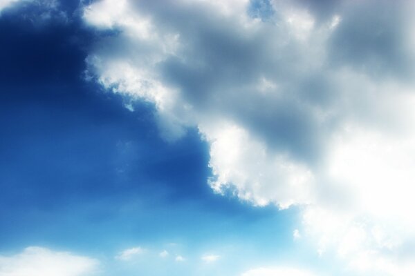 Bright sky with clouds illuminated by sunlight