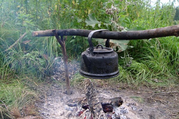 A fire in the taiga and a black kettle