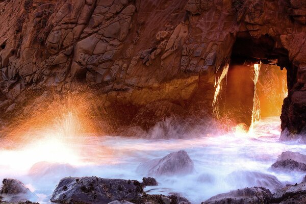 A bright column of light through the sea grotto in a splash of water