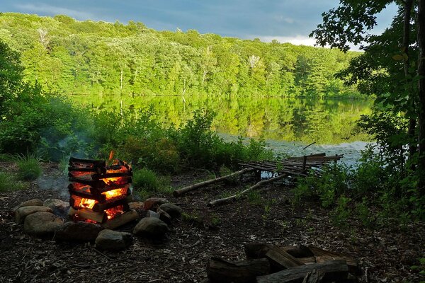 Bonfire on the background of a deep lake