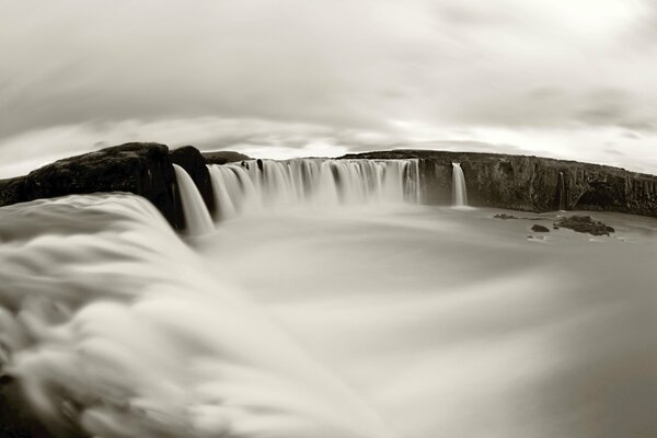 The black and white poster of the waterfall is impressive