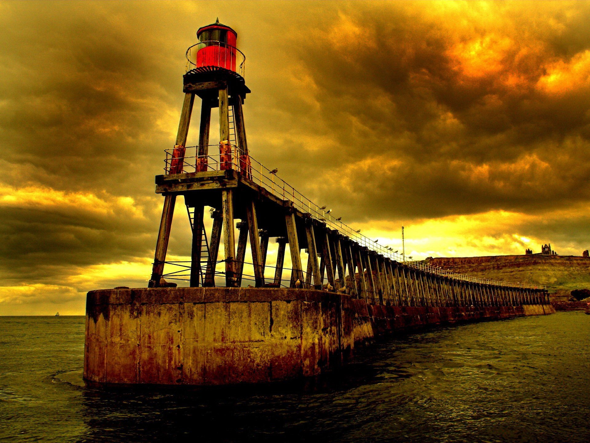 lighthouse clouds water