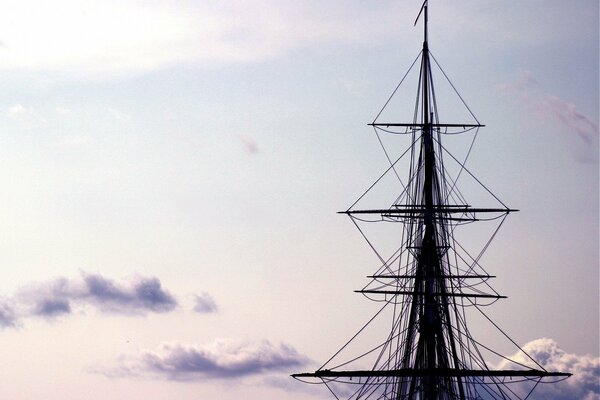 The mast of the ship against the background of clouds