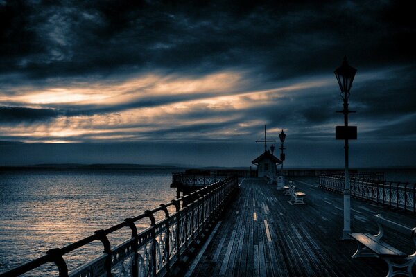 Grey clouds in the evening over the pier