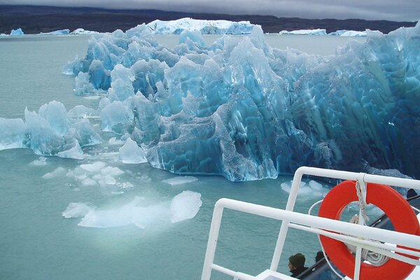 Photo from a ship with a lifebuoy on the background of ice around