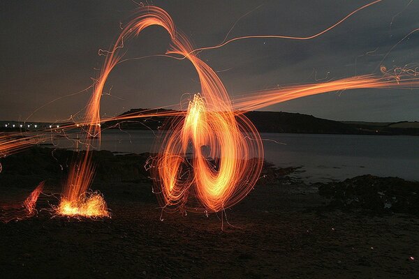 Imagen de fantasía de una chispa de fogata en una playa nocturna