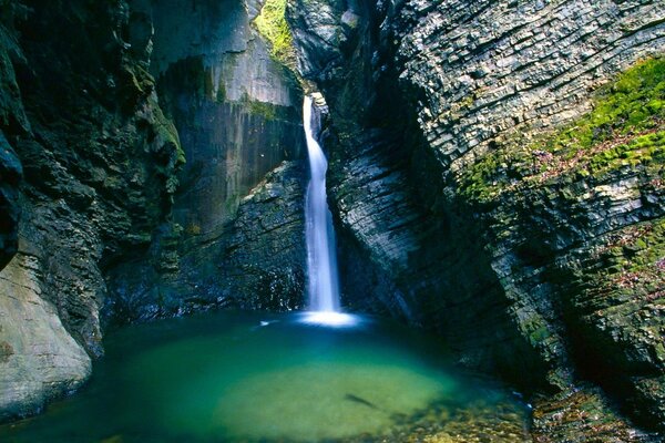 Ein strahlender Wasserfall fließt von den Steinen ab