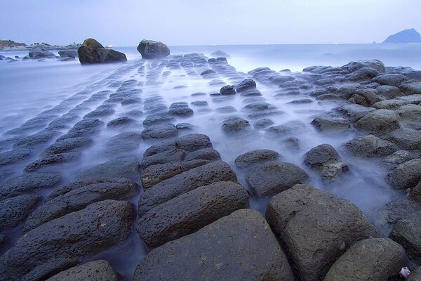 Rocky seashore, shrouded in fog