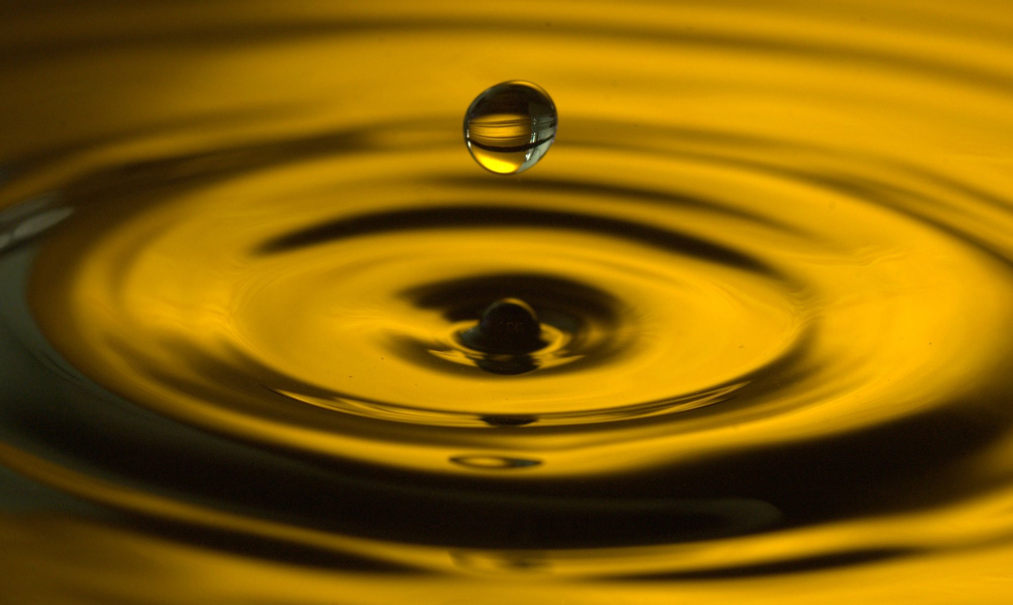 water drop splash following macro ripples yellow