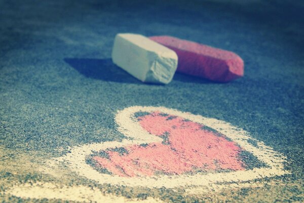 Drawing of a heart in chalk on asphalt