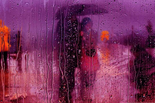 A couple under an umbrella on an autumn rainy evening