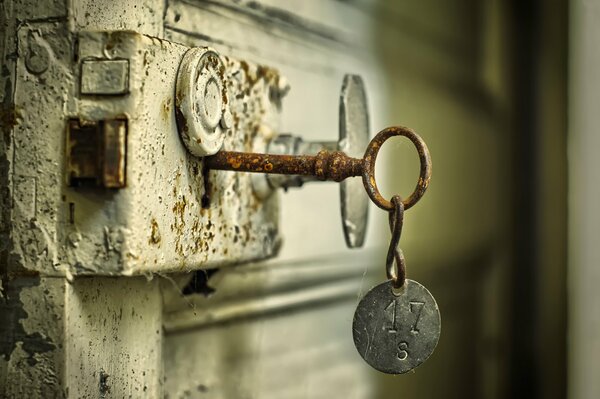 A rusty key is inserted into the lock